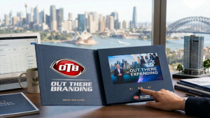 High-end video brochure open on a desk in Sydney, showing HD screen, buttons and premium marketing setup.