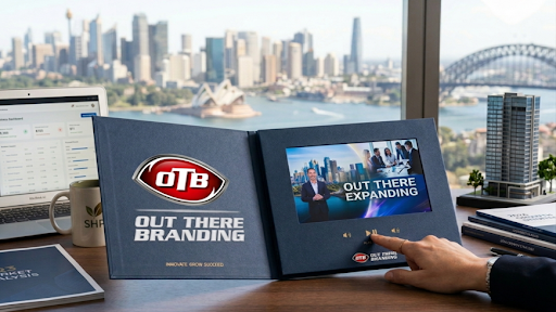 High-end video brochure open on a desk in Sydney, showing HD screen, buttons and premium marketing setup.