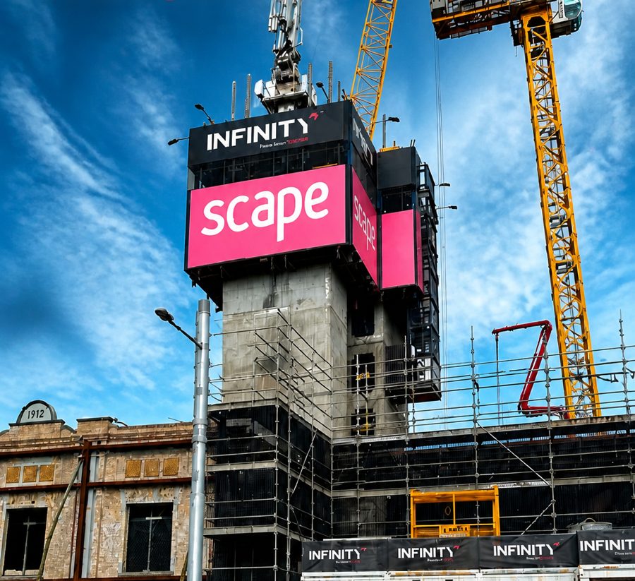 Scape HEIGHTS building wrap and crane signage on a construction site